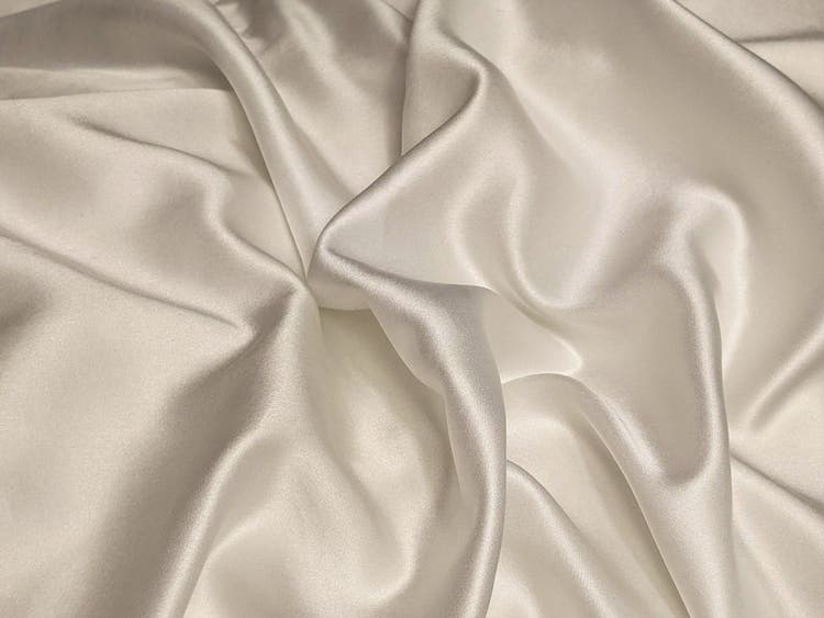 Close-up of white satin fabric folds