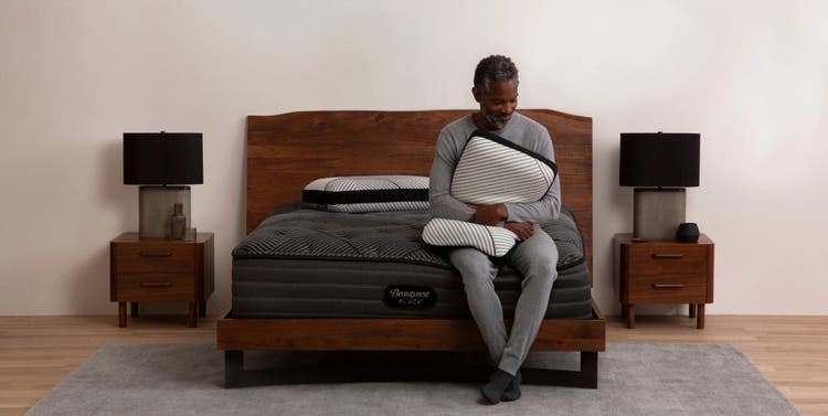 Modern bedroom with mattress and pillows