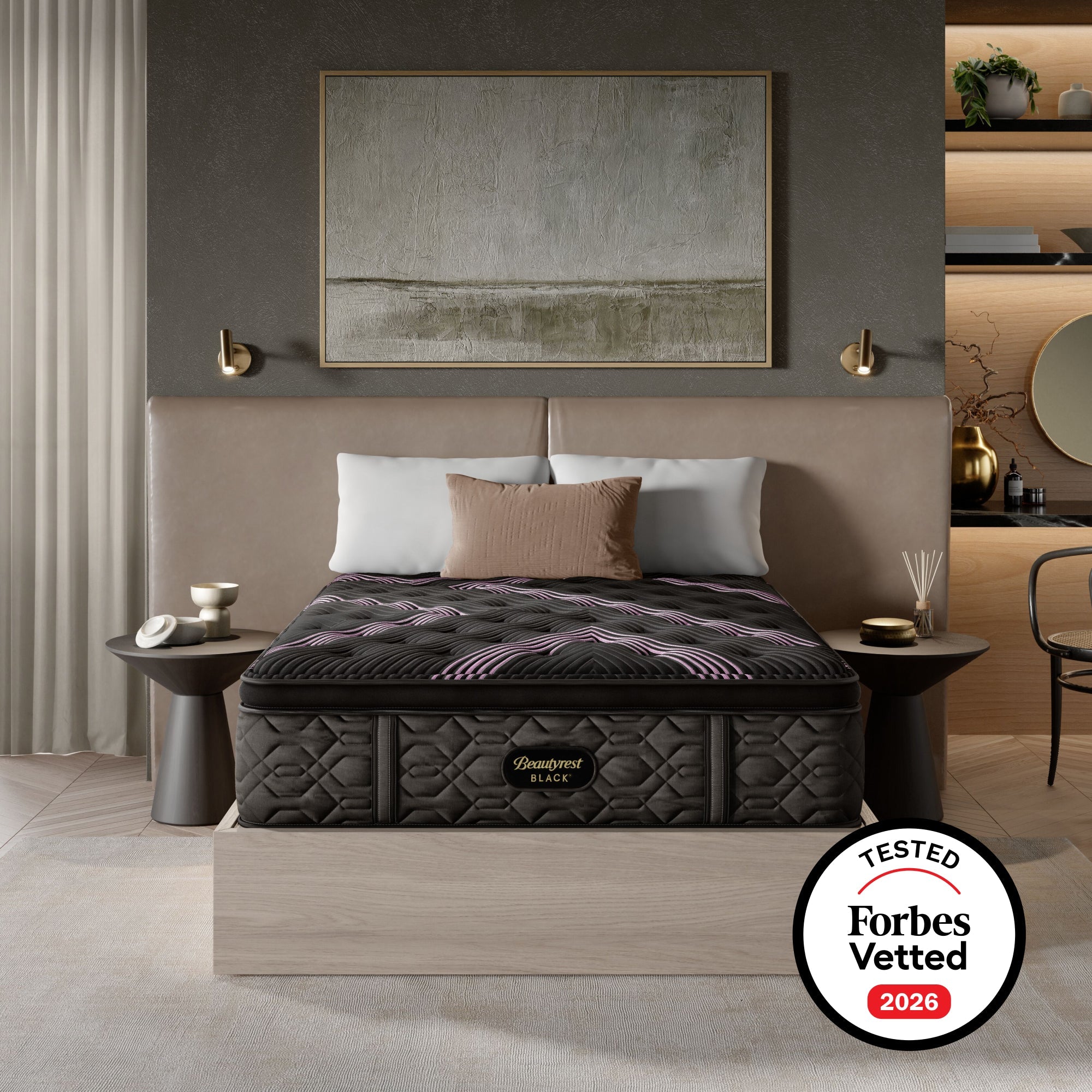 A luxury bed with a dark quilted mattress and matching headboard in a modern bedroom setting, featuring a 'Forbes Vetted 2026' badge overlay in the bottom right corner.